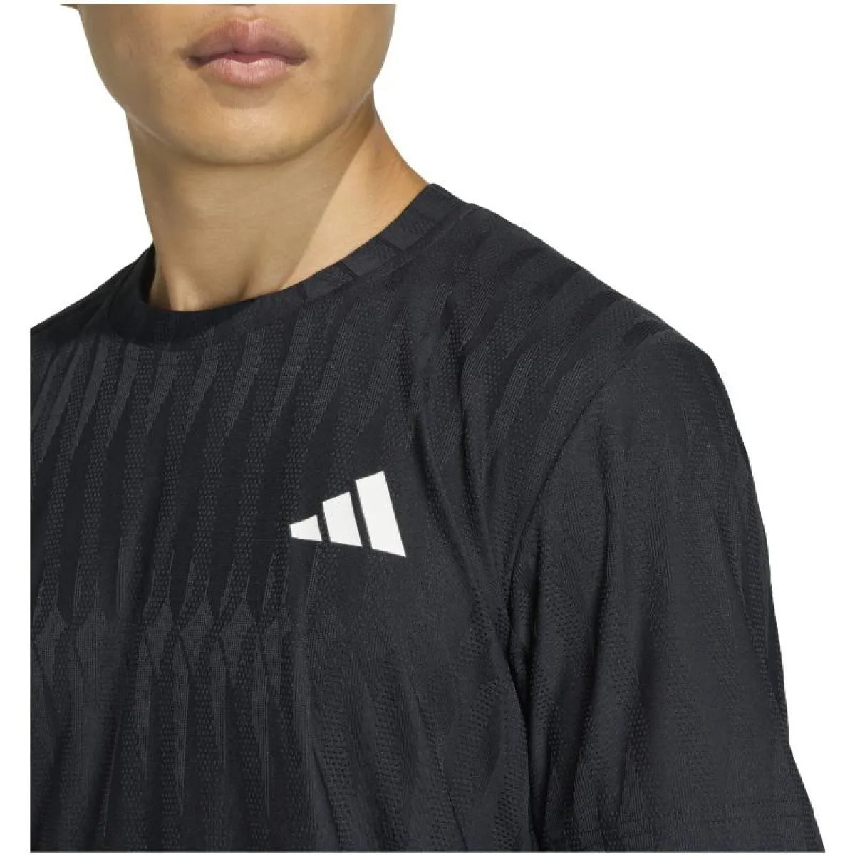 Black Adidas Tennis Freelift T-Shirt in XL displayed on a hanger, showcasing lightweight sportswear design.