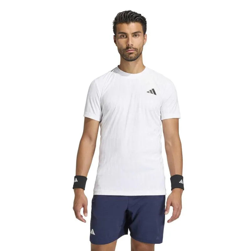 White Adidas Tennis Freelift T-Shirt in small size, featuring lightweight fabric and athletic fit for comfortable sportswear.